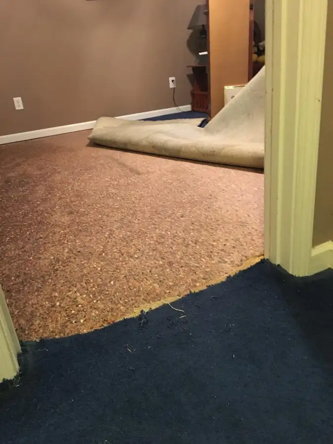 Carpet pad removal revealing water damage during Drying & Dehumidification in Gun Barrel City